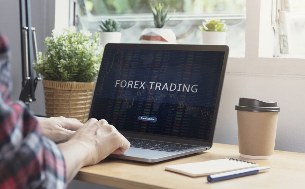 A detailed guide to Understanding Forex to Get Started in Forex Trading displayed on a computer screen with forex market graphs in the background.
