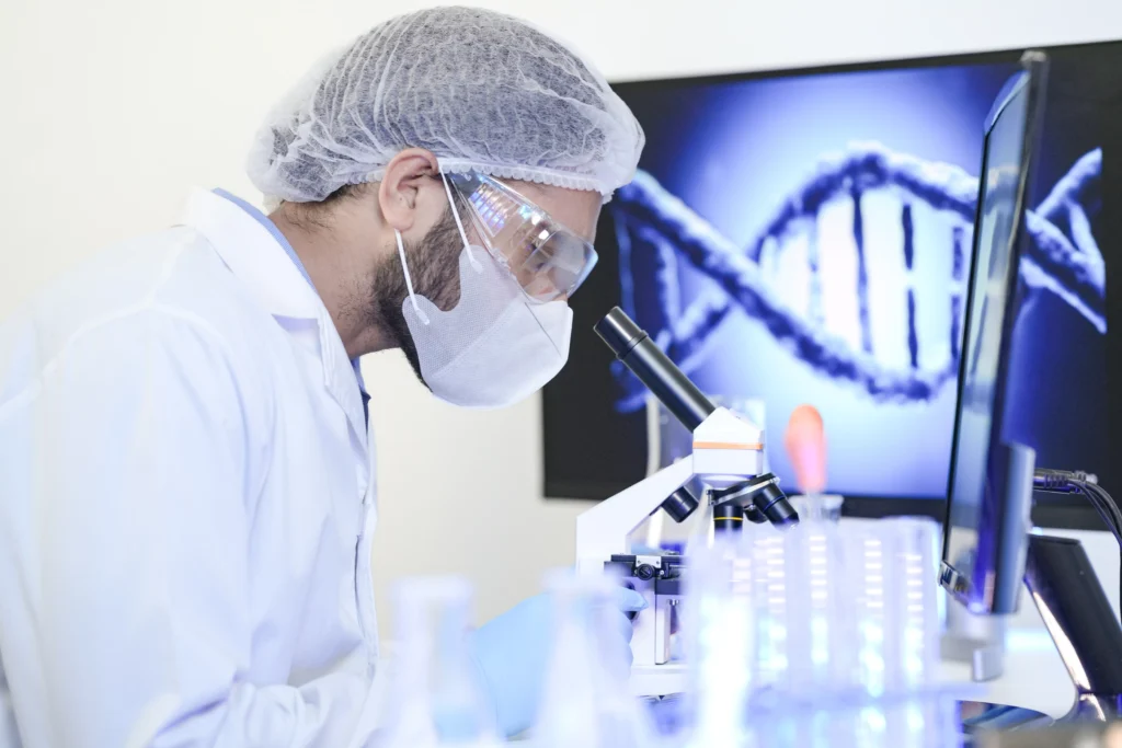Scientist examining DNA under a microscope symbolizing Global Genomics Breakthroughs