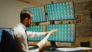 A forex trader analyzing multiple monitors with technical charts to apply the best forex strategies using multi timeframe indicators in 2025.