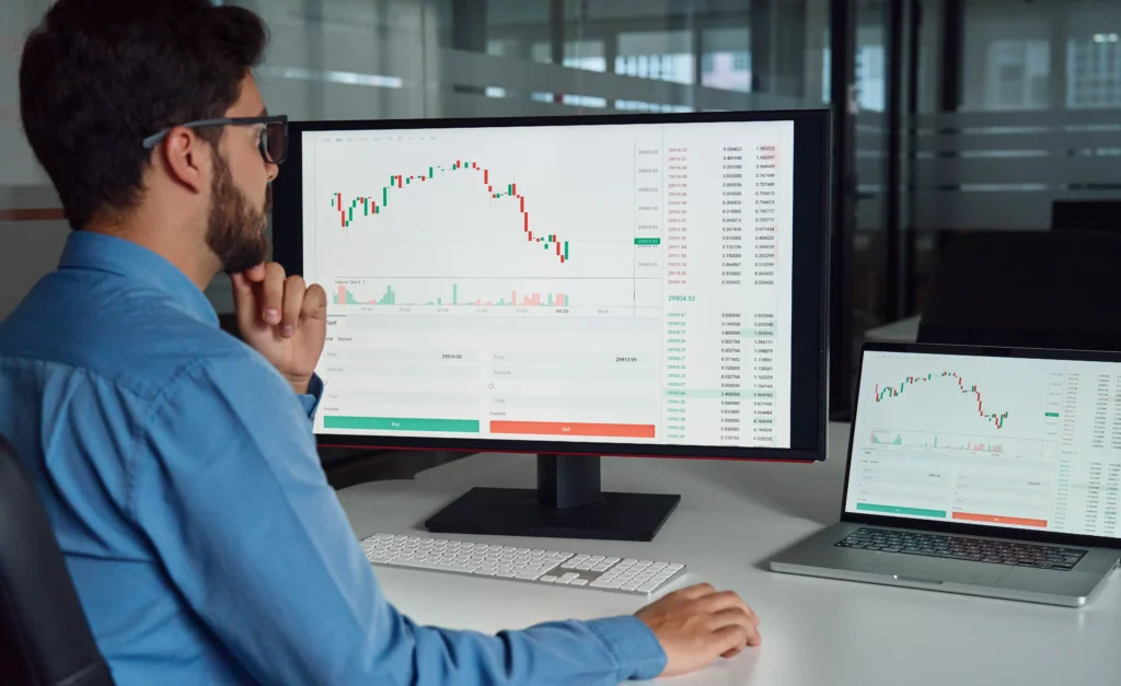 Man analyzing forex charts on MetaTrader Forex Demo Account for practice trading.
