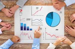 People analyzing market charts and volatility indicators on a report table.