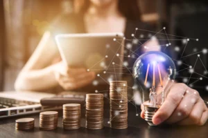 Smart Money concept with stacked coins, tablet, and glowing light bulb.