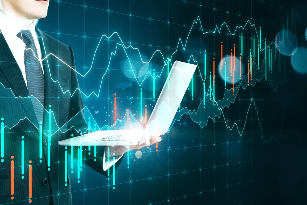 Professional trader analyzing forex charts on laptop, representing Telegram Trading Signals and their market impact.