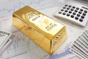 Gold bullion bar on financial charts showing investment growth and inflation trends in 2025.