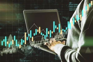 Person analyzing live Forex charts on a laptop with rising candlestick patterns.