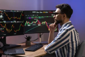 A trader analyzing market charts on multiple monitors, studying price movements and patterns for short-term and positional trading strategies.