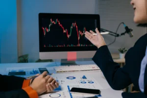 Traders analyzing live forex charts on computer screen during a scalping strategy discussion