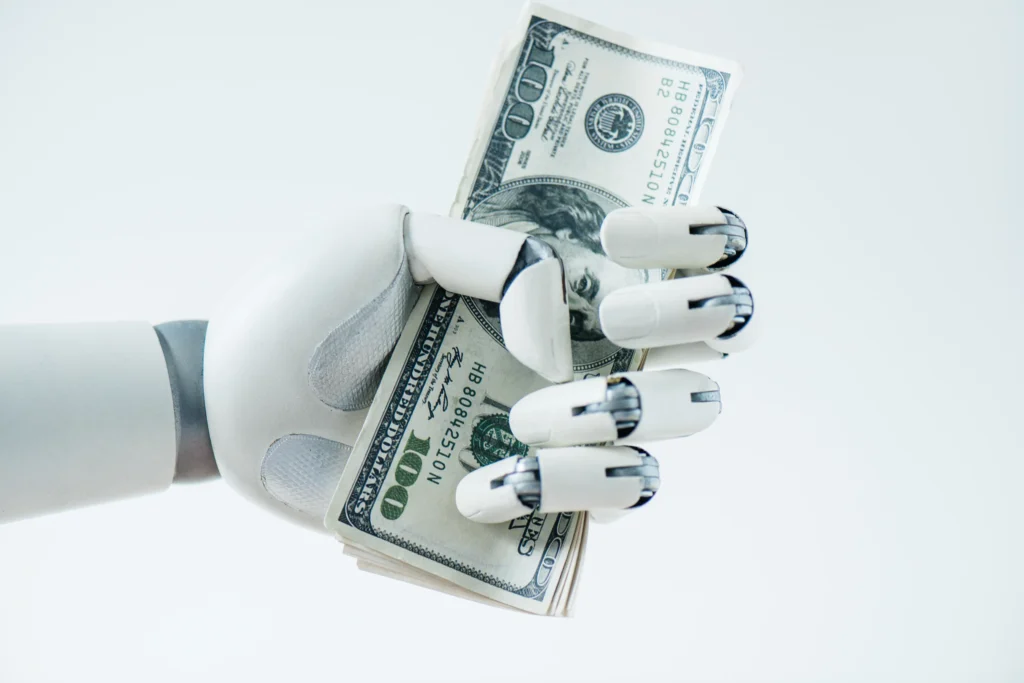 Robot hand holding dollar bills representing AI investment opportunities and financial growth.