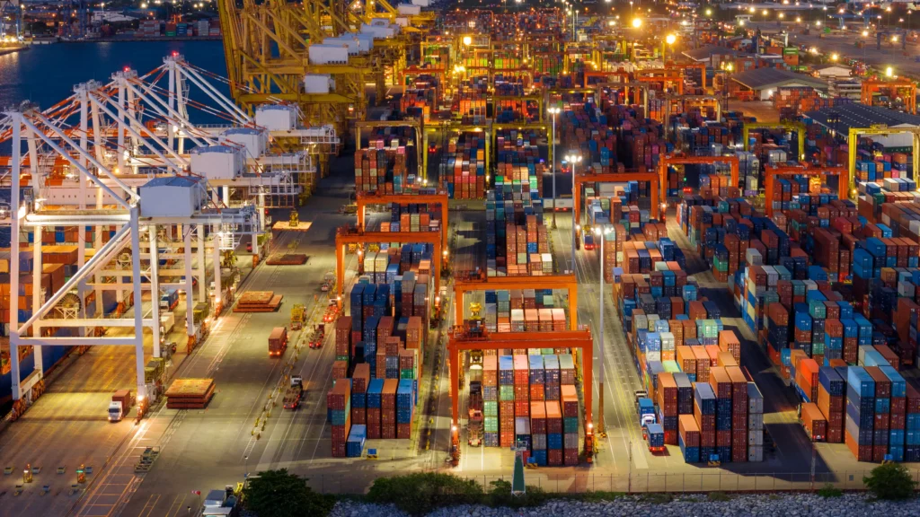 Night view of a busy container port showing global Supply Chain Reconfiguration.