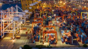Night view of a busy container port showing global Supply Chain Reconfiguration.