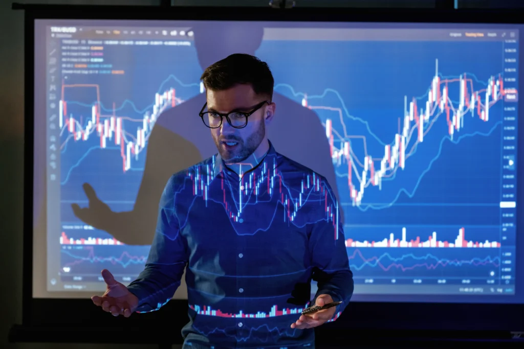 A financial analyst presenting market sentiment using projected trading charts.
