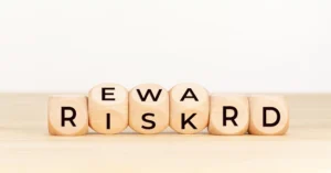 Wooden blocks spelling the words risk and reward representing trading balance and decision-making in Forex.