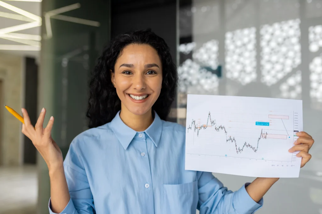 Trader analyzing forex chart with MetaTrader indicators in an office.