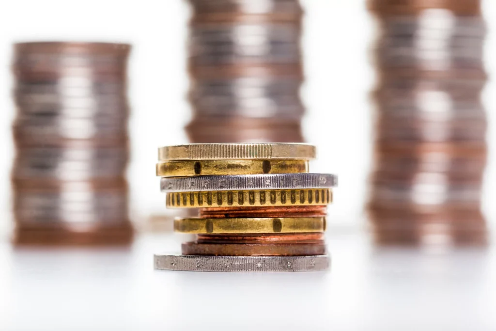 Gold silver and copper record highs represented by stacked coins showing rising metal value in 2025.