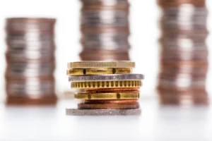 Gold silver and copper record highs represented by stacked coins showing rising metal value in 2025.