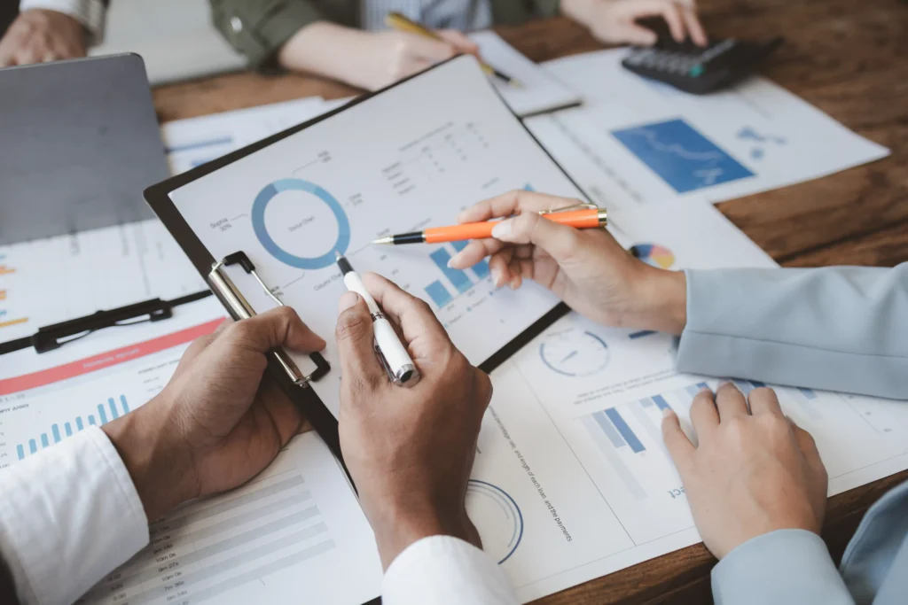 Global Financial Review 2025 — professionals analyzing market data, charts, and financial trends for global investment insights.