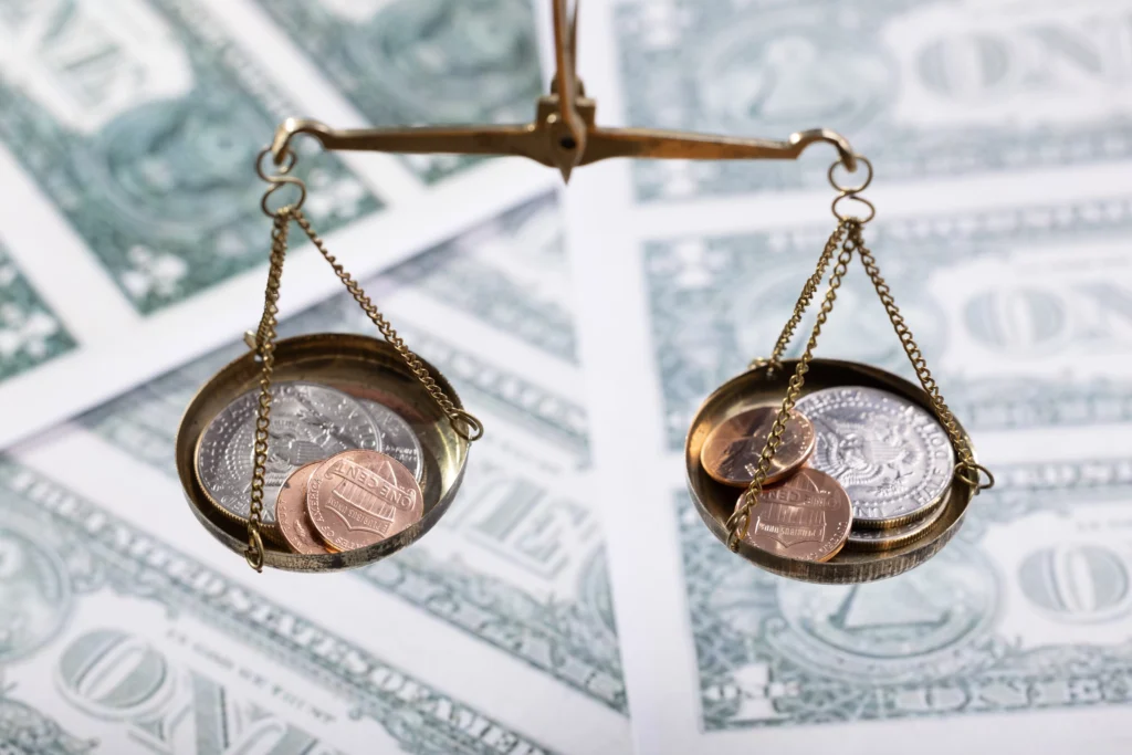 Balanced investment strategy concept showing coins balanced on scales, symbolizing risk and reward balance in investing.