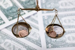 Balanced investment strategy concept showing coins balanced on scales, symbolizing risk and reward balance in investing.