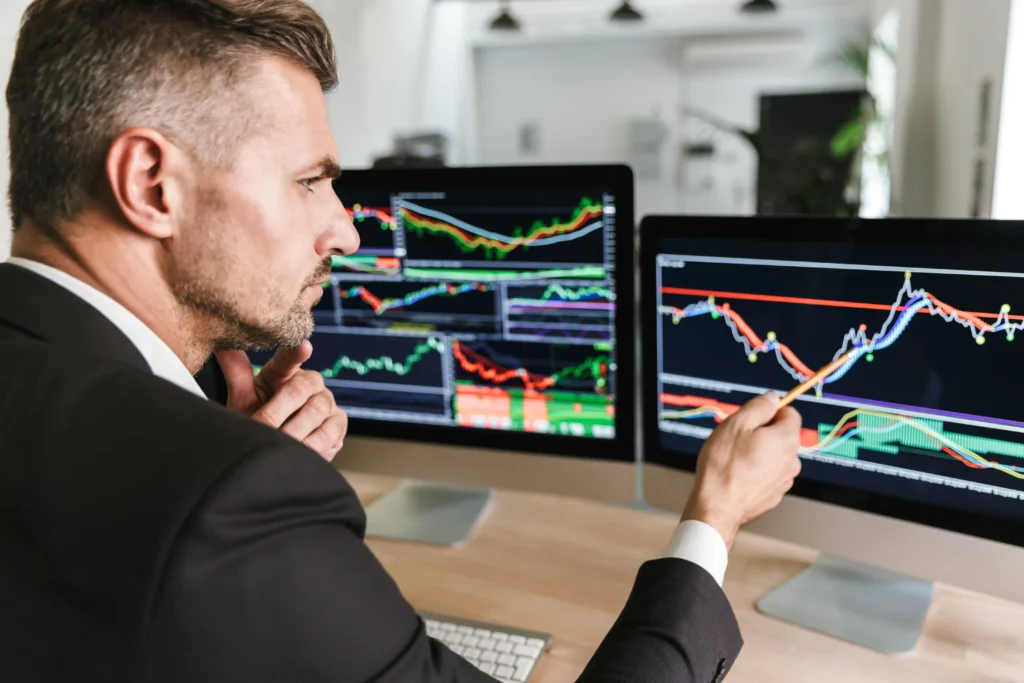 Professional forex trader analyzing daily market charts and identifying factors that affect daily trades in 2026